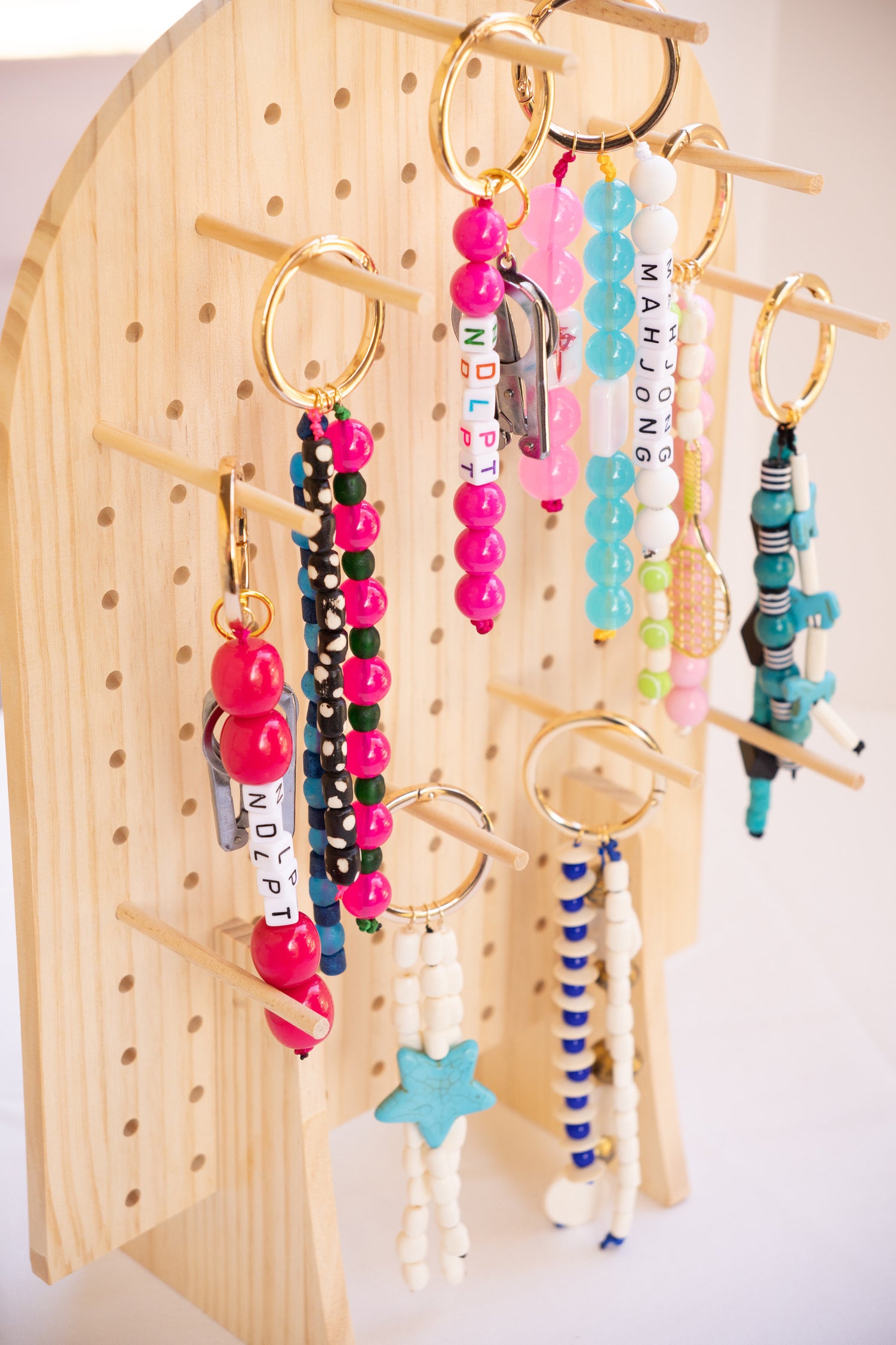 Colorful Bag Charms hanging on a wooden pegboard