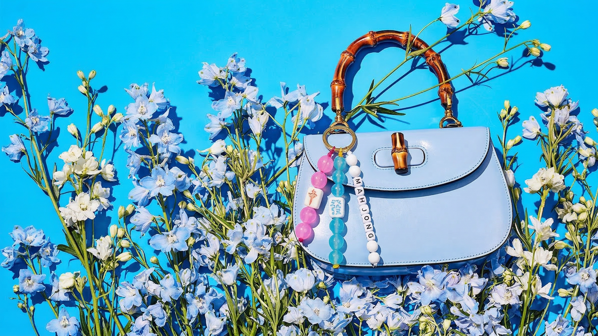 Blue handbag with floral decorations on a blue background