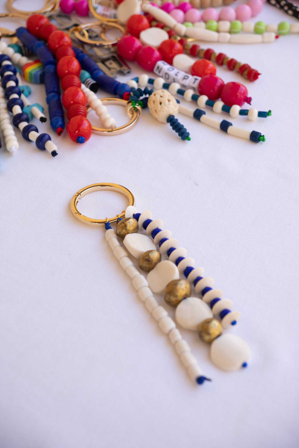Colorful beaded Bag Charms on a white surface