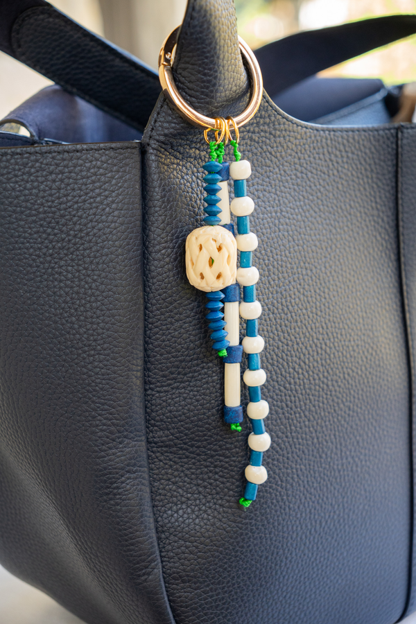 Beaded keychain attached to a black leather bag