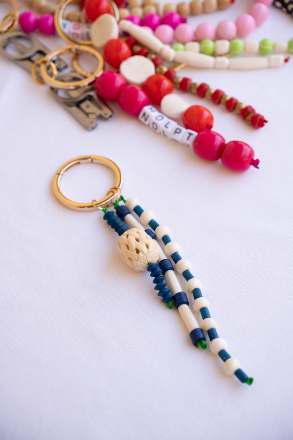 Colorful beaded keychains on a white surface