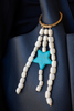 Beaded accessory with a blue star on a dark blue textured surface