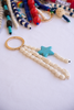 Beaded keychain with star charm on a white background