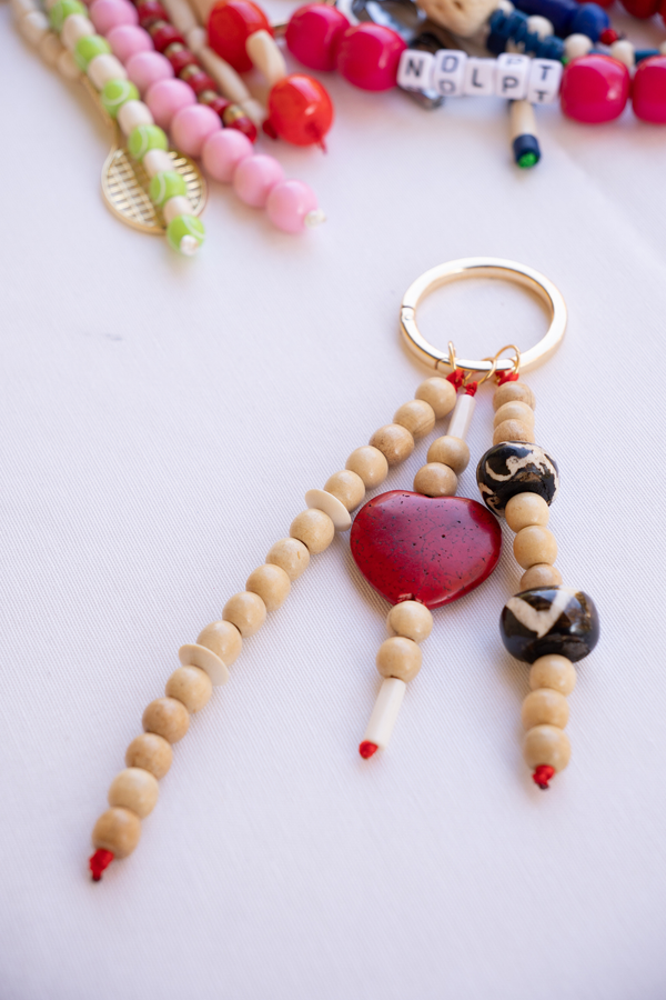 Beaded keychain with heart charm on a white background