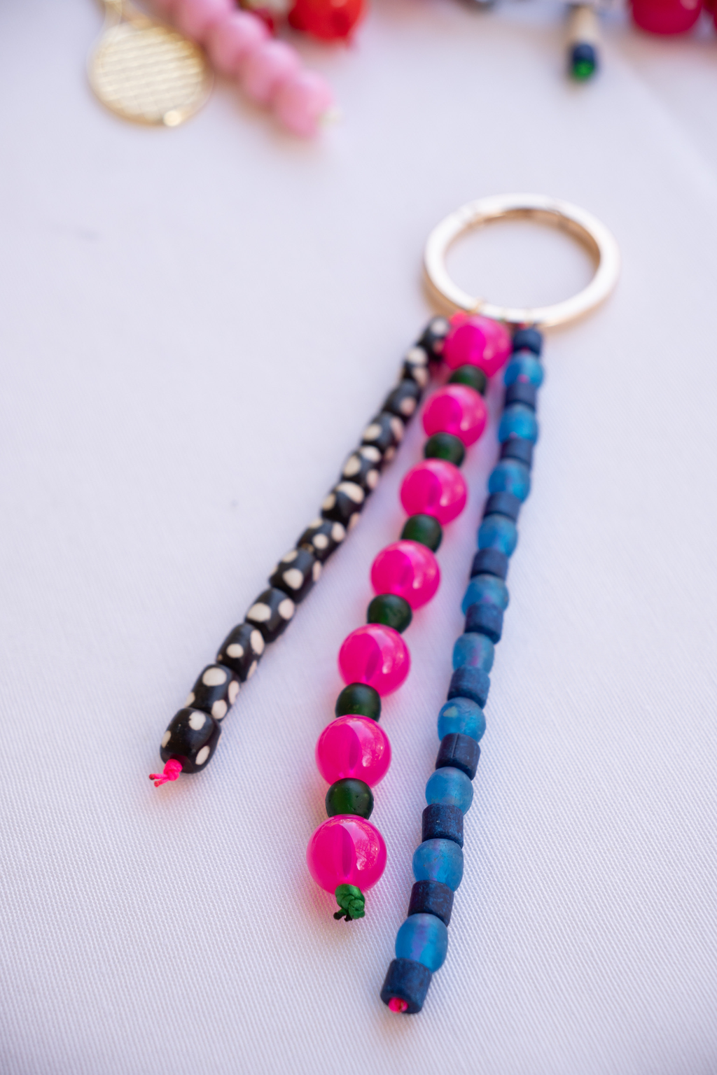 Colorful beaded keychains on a light gray background