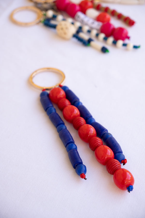 Beaded keychain with red and blue beads on a white background