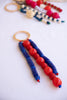 Beaded keychain with red and blue beads on a white background