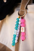 Colorful beaded keychain with 'Mah Jong' on a beige bag.